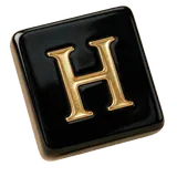 A black tile with the gold letter H