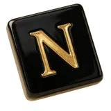 A black tile with the gold letter N